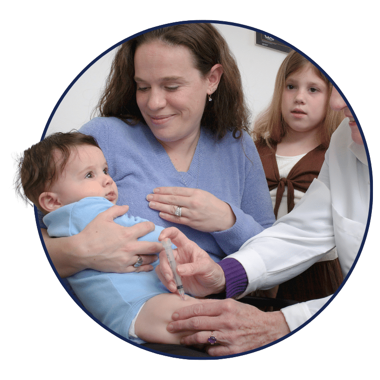 patient holding a baby with doctor